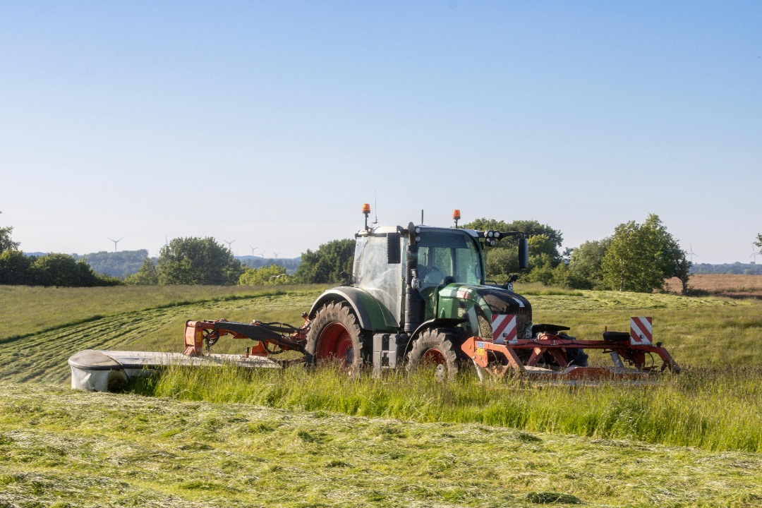 Tractor performing mowing management